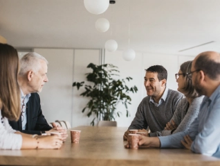people having a conversation at a table 