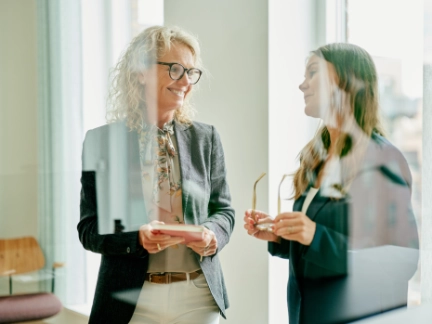 Atradius Danish colleagues talking in the office