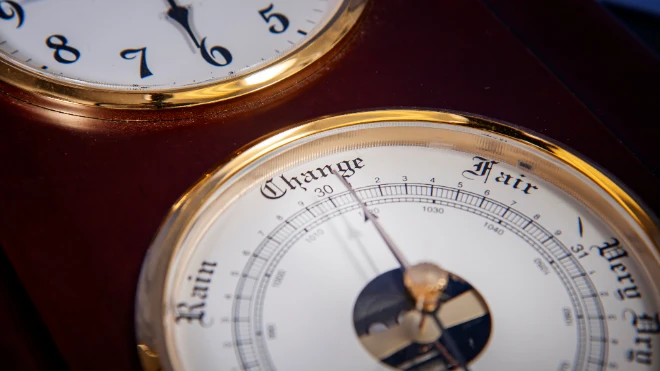 Close-up: Vintage wood/brass weather station shows a barometer face with 'Change, Rain, Fair' below a clock face.