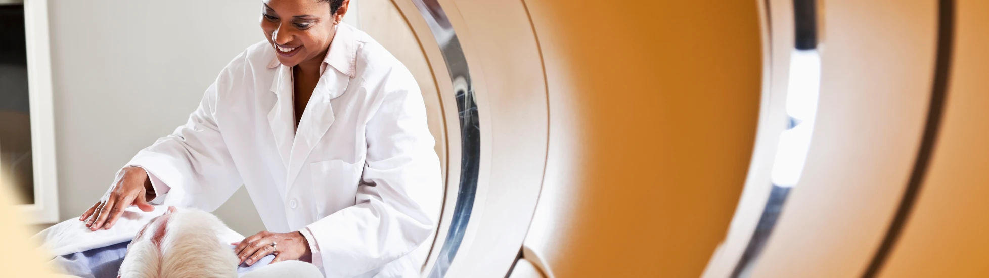 Medical scanning machine with patient and doctor in the back ground