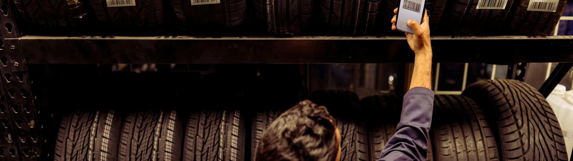 Automotive worker checking tyres