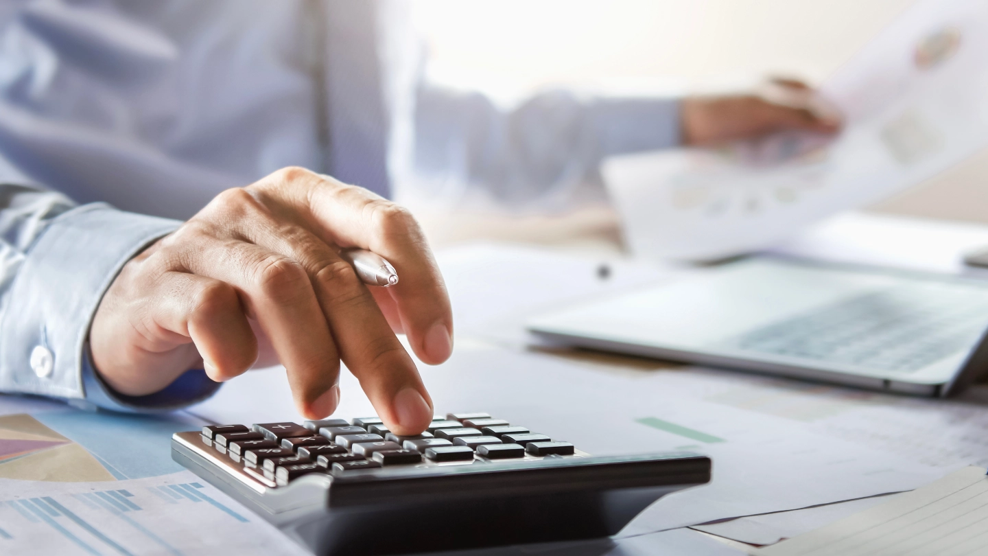 worker using a calculator image