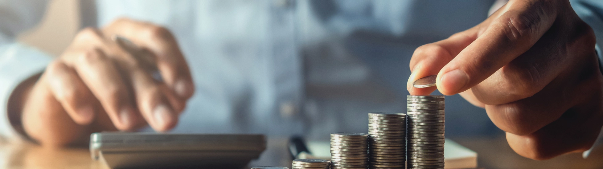 saving money with hand putting coins on stack concept financial